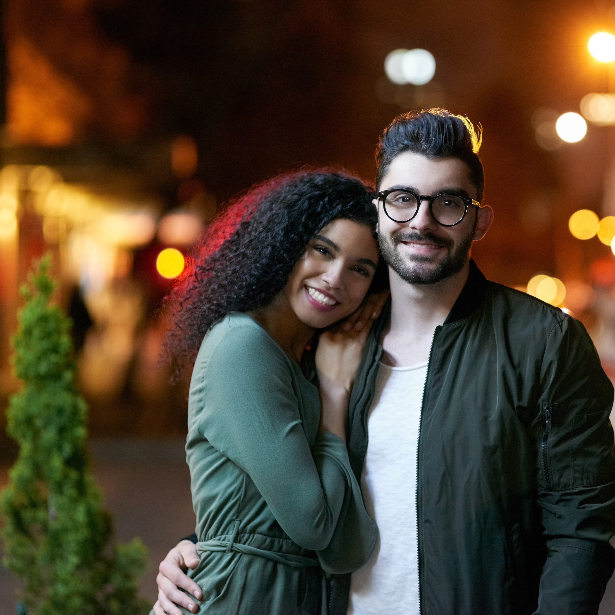 Young love. Portrait of a happy young couple outdoors at night.